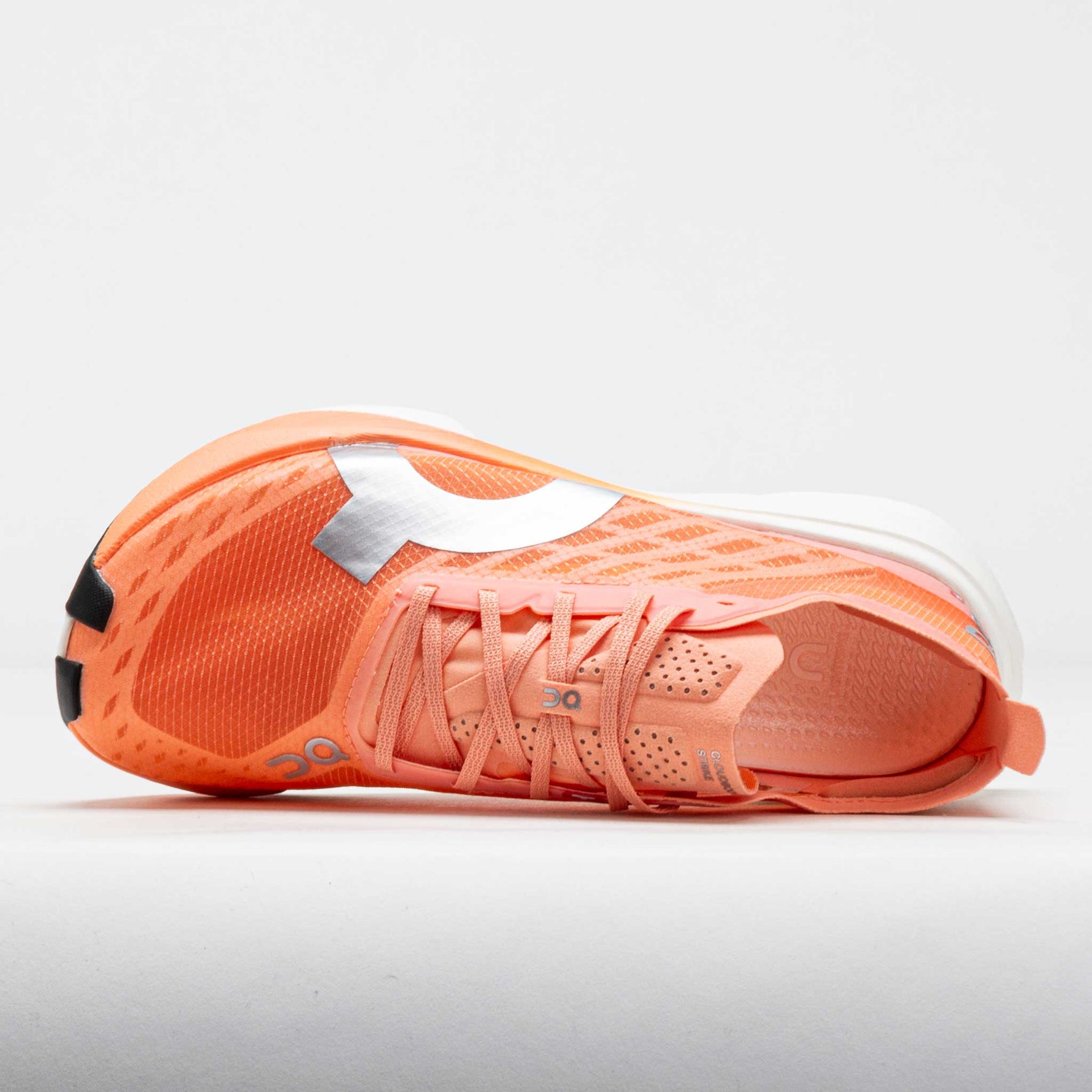 On Cloudboom Strike women's running shoe in coral orange and white colorway