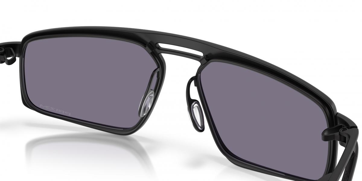 Oakley Bushwick sunglasses front close-up with reflection, satin black frame and grey Prizm lenses