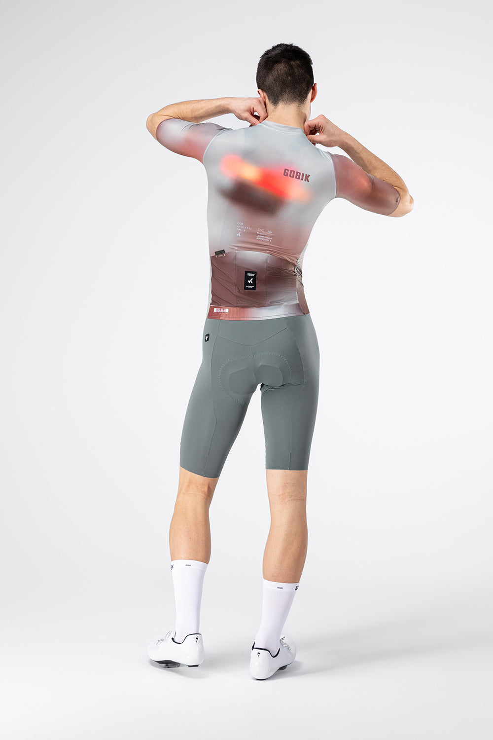 Rear view of male model wearing Gobik Attitude 2.0 jersey in Flank colorway with bib shorts