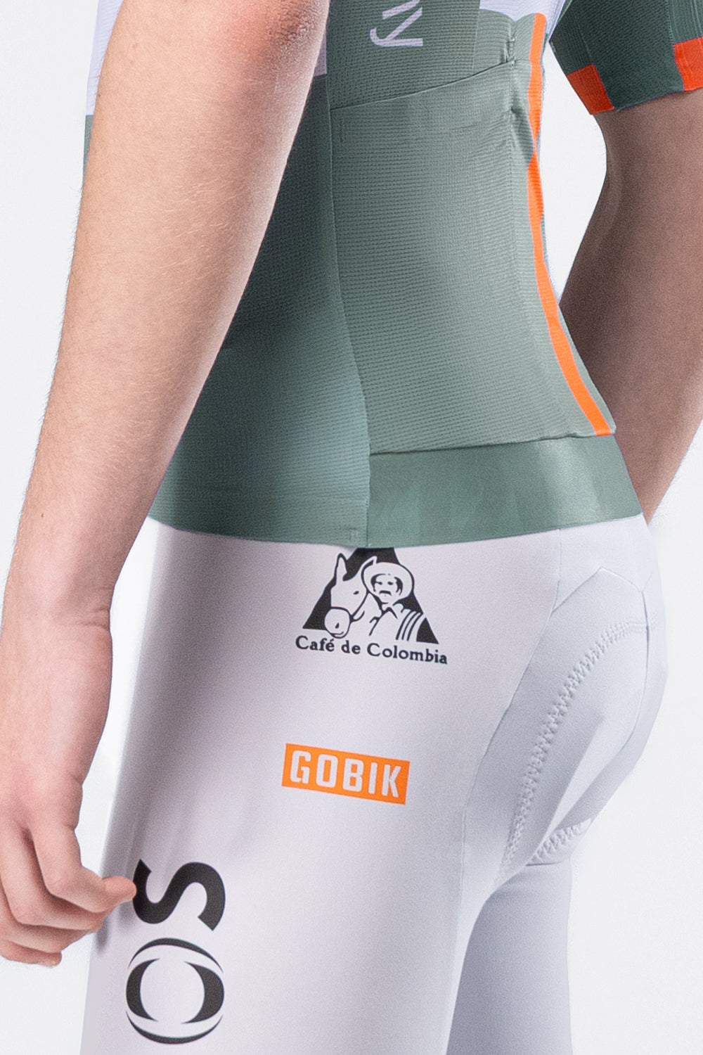 Gobik Ineos Netcompany men's cycling jersey rear view, green and white with orange trim