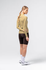 Female model wearing Gobik Avalon Long Sleeve Jersey in Keemun, three-quarter rear view