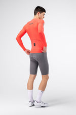 Gobik Avalon Long Sleeve Jersey in Lava color, male model rear view showing back pockets