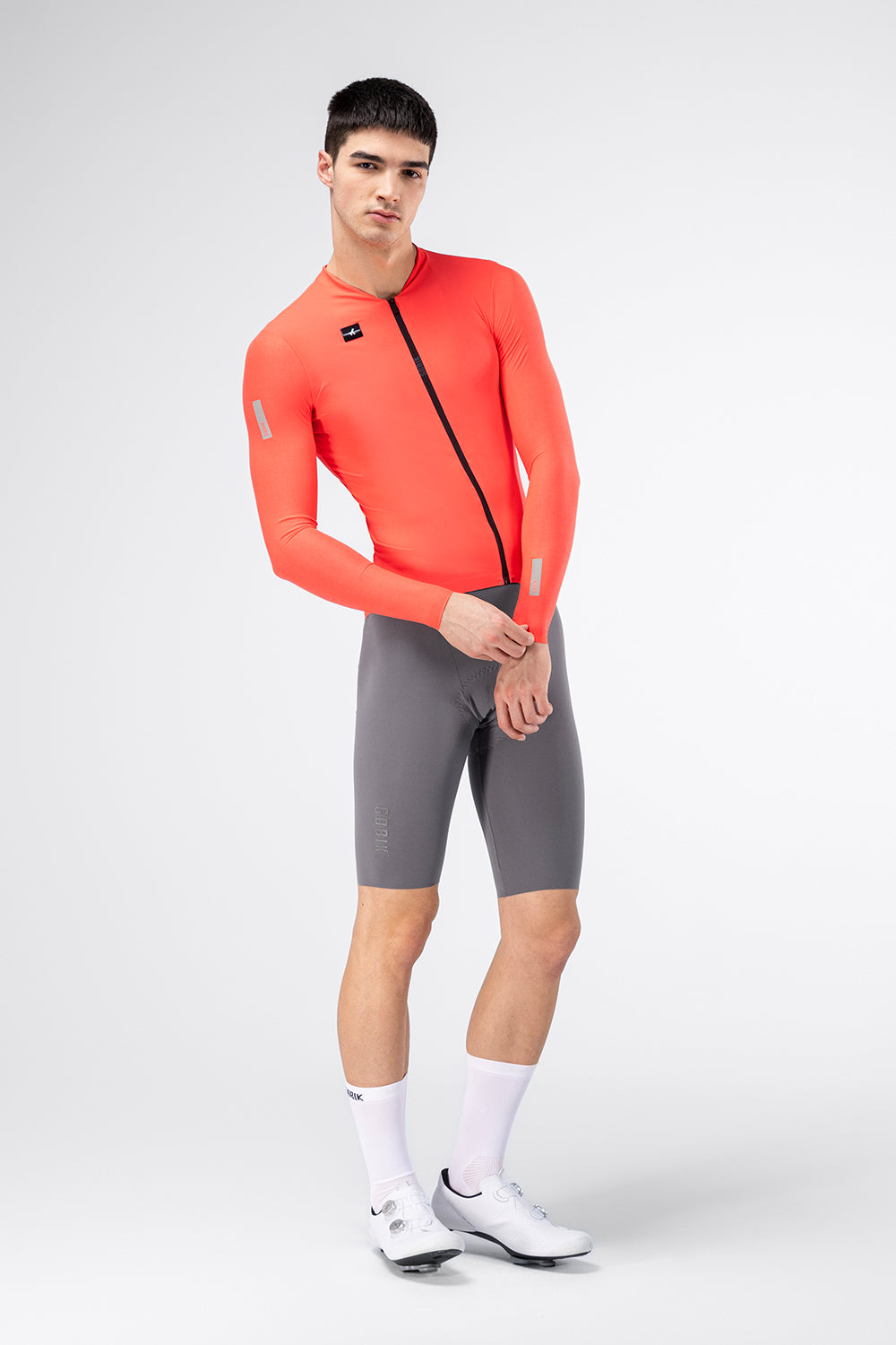 Gobik Avalon Long Sleeve Jersey in Lava color, male model front view with reflective details visible