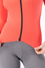 Close-up of Gobik Avalon long sleeve jersey front zipper in lava coral color