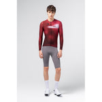 Male model wearing Gobik Vanquish long sleeve cycling jersey in Monarch red colorway, front view
