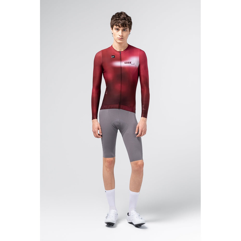 Male model wearing Gobik Vanquish long sleeve cycling jersey in Monarch red colorway, front view