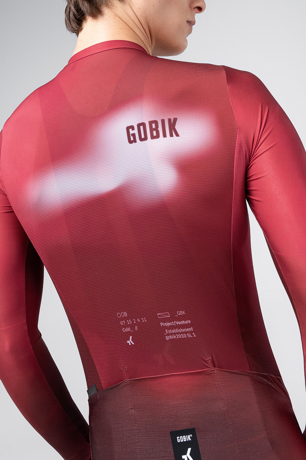 Close-up back view of Gobik Vanquish long sleeve jersey showing GOBIK branding in Monarch red