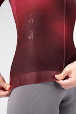 Close-up detail of Gobik Vanquish jersey hem and silicone gripper in Monarch burgundy colorway