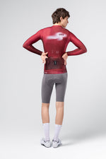Rear view of Gobik Vanquish long sleeve jersey in Monarch burgundy showing back pockets and branding