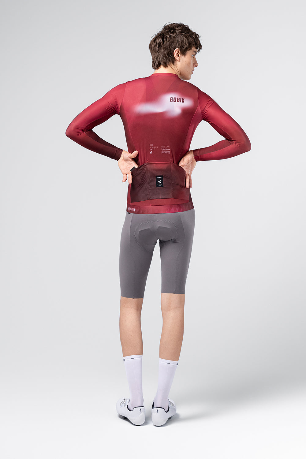 Rear view of Gobik Vanquish long sleeve jersey in Monarch burgundy showing back pockets and branding