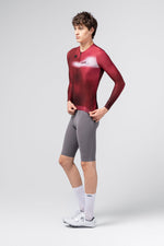 Gobik Vanquish long sleeve cycling jersey in Monarch burgundy red worn by male model