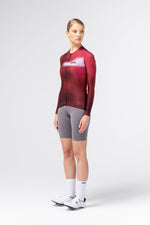 Female model wearing Gobik Vanquish long sleeve jersey in Monarch red, three-quarter front view