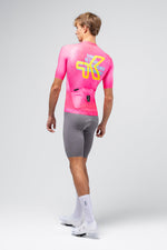 Gobik CX Pro 4.0 cycling jersey in neon pink Drip colorway, rear view on male model