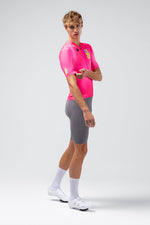 Gobik CX Pro 4.0 cycling jersey in neon pink Drip colorway worn by male model