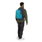 Man wearing Osprey Daylite Plus backpack in Night Shift colorway, rear view showing teal main body