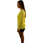 Woman modeling Legg One More Mile neon yellow long sleeve athletic top with black shorts