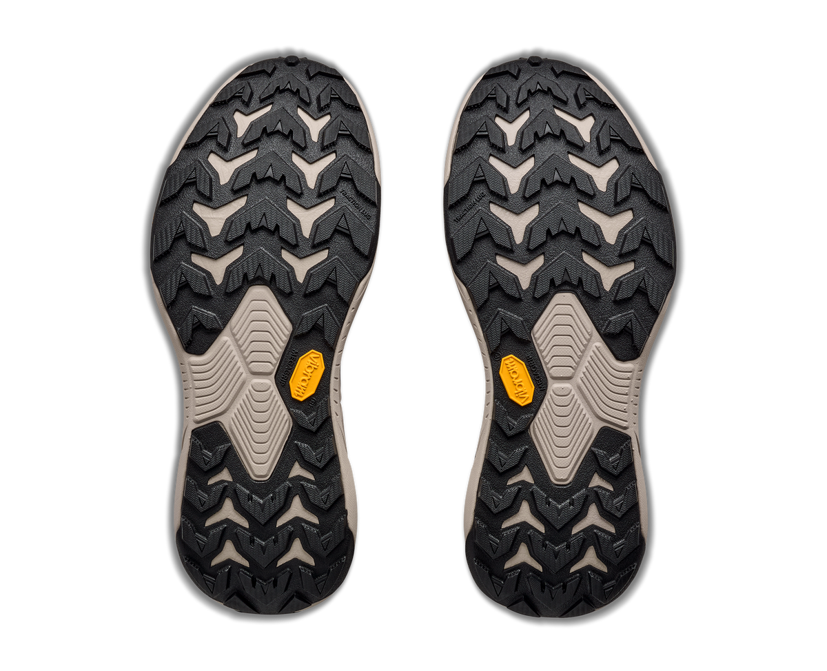 Bottom view of pair of Hoka Transport Hike GTX boots showing aggressive Vibram lug outsole pattern