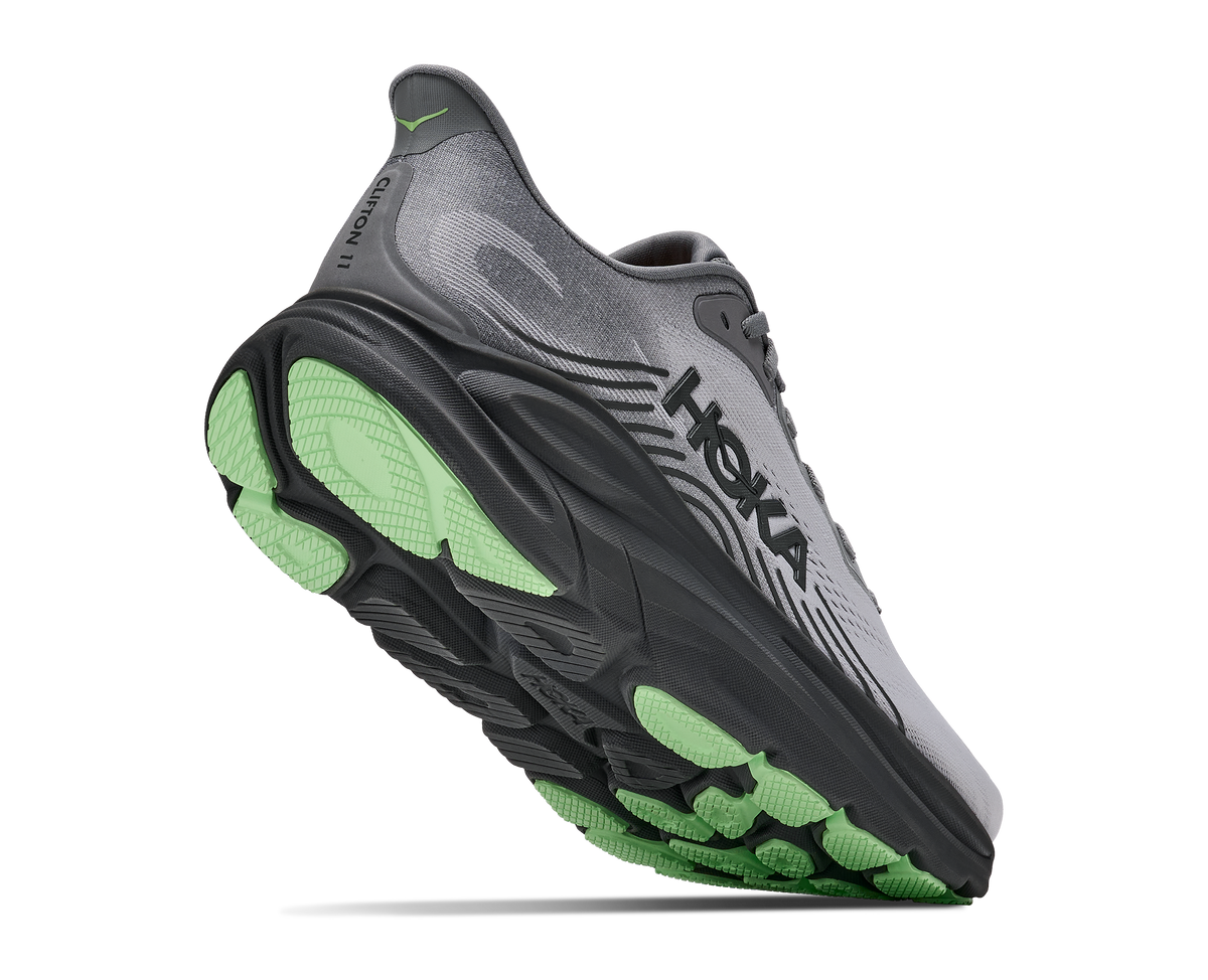 Close-up bottom angle of HOKA Clifton 11 showing green and black outsole tread pattern