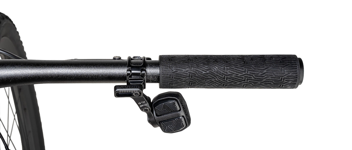 Close-up of SRAM GX shifter and black textured handlebar grip on Specialized Epic 9 Expert mountain bike.
