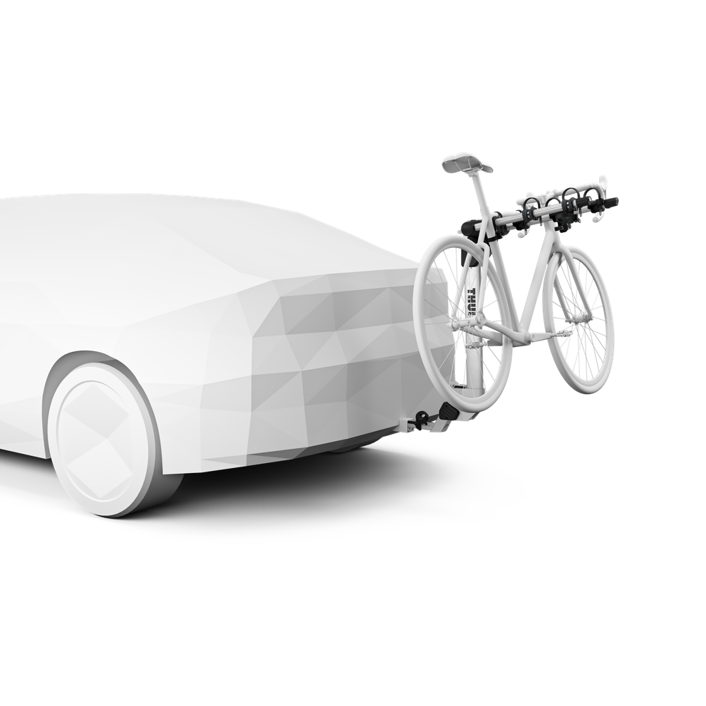 Thule Helium Pro 3 bike hitch rack mounted on white car with bicycle loaded