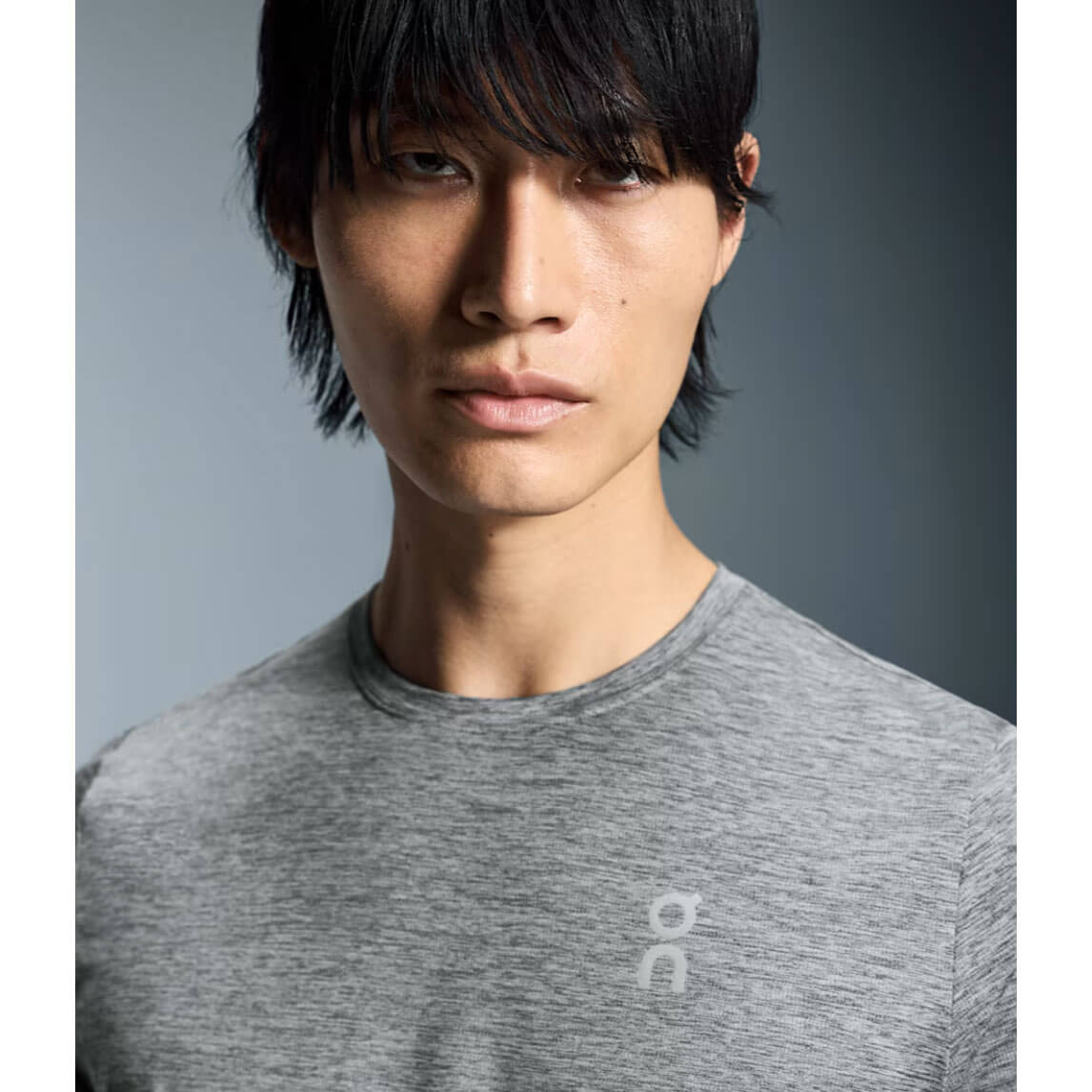 Asian male model wearing heather grey On Core Long-T shirt in professional studio portrait