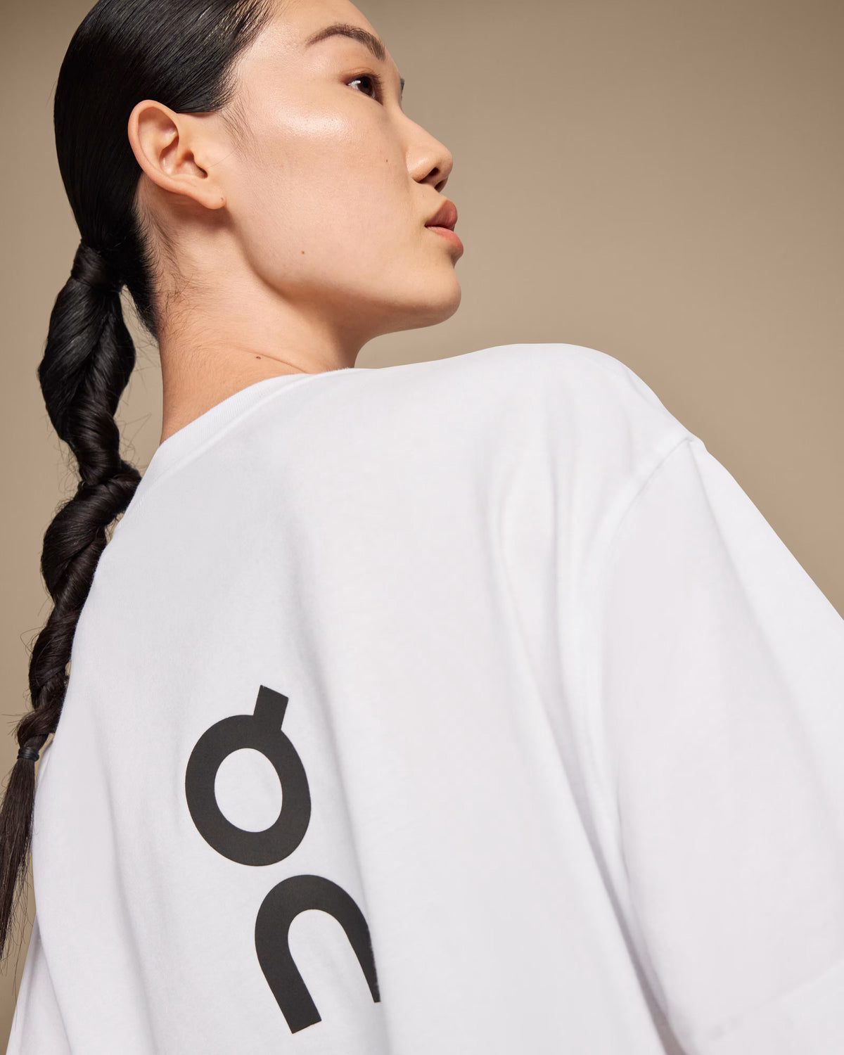 Close-up detail of On Running Club-T white t-shirt back showing large On logo print