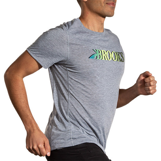 Man running wearing Brooks Distance Short Sleeve 3.0 in heather ash gray with gradient logo