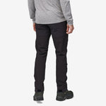 Man wearing black Patagonia Point Peak Trail Pants with hiking boots