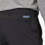 Close-up of black Patagonia Point Peak Trail Pants showing logo and pocket detail