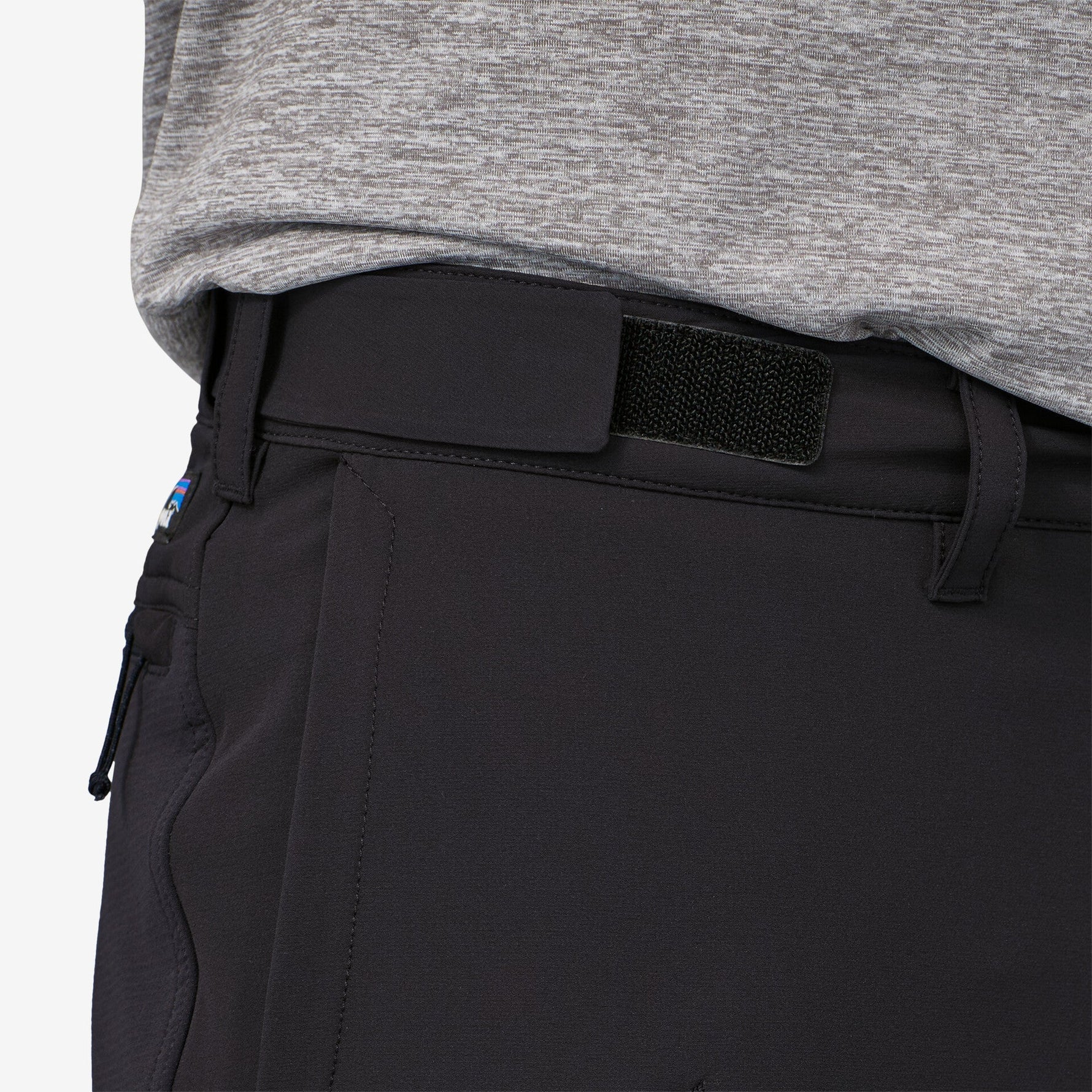 Close-up of black Patagonia trail pants waistband with velcro patch detail