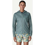 Woman wearing Patagonia Houdini Jacket in Blue Sage color with hood up