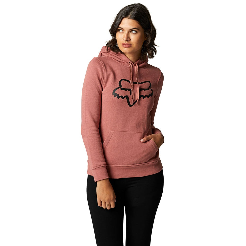 Woman wearing Fox Racing pullover hoodie in dusty rose color with fox logo