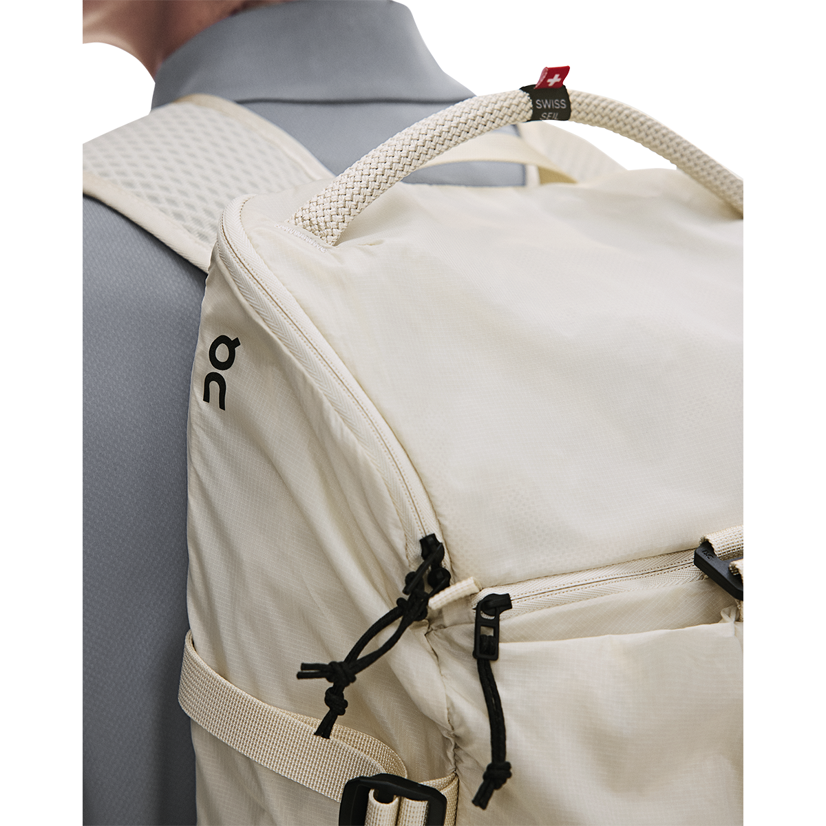 On Speed Pack 18L Lite backpack in cream, close-up detail shot on model