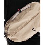 On Sling Pack 9L in biscuit beige worn as crossbody bag with Swiss Seil rope handle