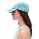 Woman wearing On Lightweight Unisex Cap in mint wash color, side profile view