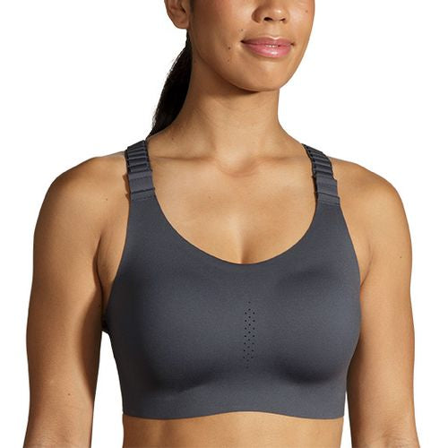 Woman wearing Brooks Dare Racerback 2.0 sports bra in asphalt gray color
