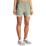 Brooks Chaser 5-inch 2-in-1 women's running shorts in pebble green colorway on model