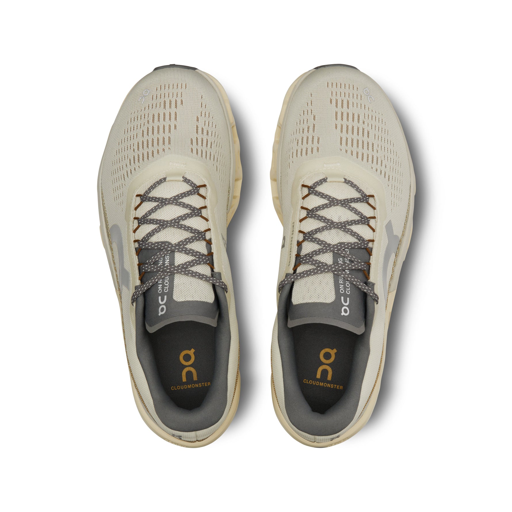 On Cloudmonster 2 running shoes in cream color, top view showing breathable mesh upper