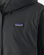 Close-up detail of Patagonia logo patch on black Torrentshell 3L Jacket chest