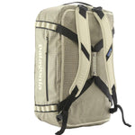Patagonia Black Hole Duffel 55L in Weathered Stone shown as backpack with harness straps deployed