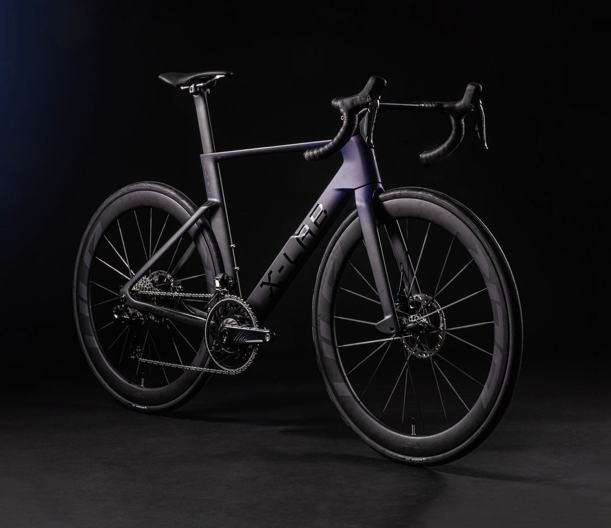 X-LAB AD9 aero road bike shown in dark purple-black finish from front three-quarter angle