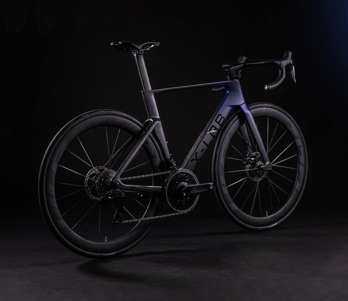 X-LAB AD9 carbon road bike in purple-black colorway photographed from rear three-quarter angle
