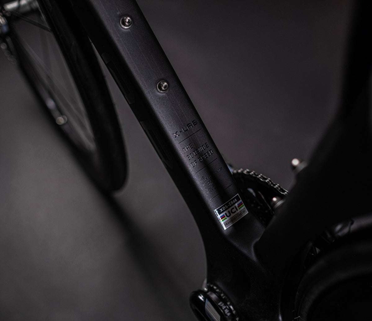 Close-up of X-LAB AD9 down tube showing brand text, UCI approval sticker and frame details