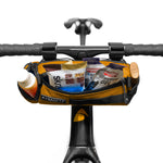 ALMSTHRE Compact Bar Bag in California Gold mounted on bicycle handlebars with snacks