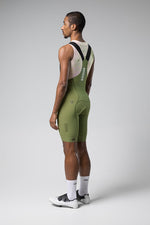 Gobik Matt Men's Bibshort in green shown from back view on model