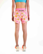 Woman wearing pink split shorts with princess tiara pattern, back view
