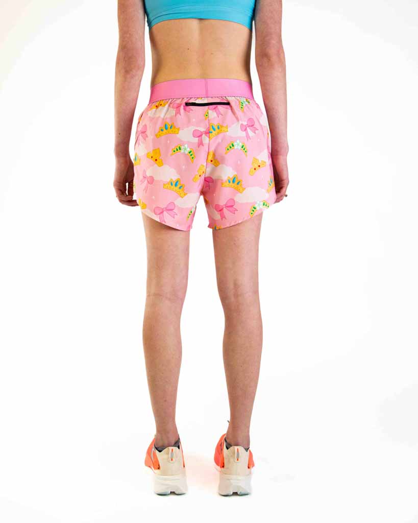 Women's pink running shorts with colorful princess tiara pattern, worn by model from behind