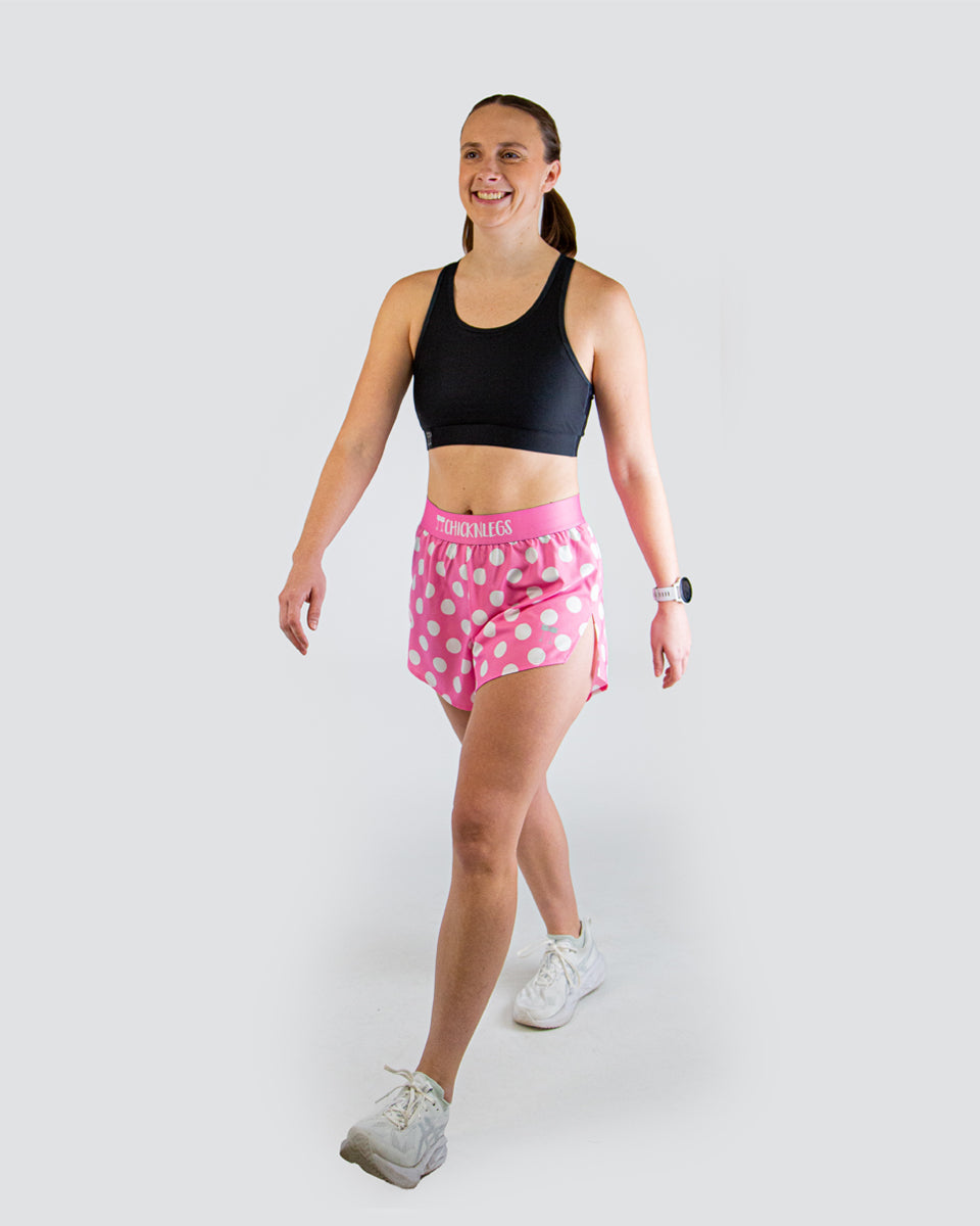 Woman wearing ChicknLegs pink polka dot athletic shorts with black sports bra