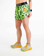 Woman wearing green ChicknLegs split shorts with pickle and jar pattern