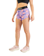 Woman wearing ChicknLegs purple split shorts with pink pig pattern and black waistband